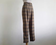 Vintage Brown Plaid Pants - Fabric : 65% polyester 35% wool - Nylon zipper on the front - Straight leg style - Pockets - Unlined - Very good vintage condition Measurements : Waist : 25" Hips : 42" Front rise : 12" Back rise : 17" Inseam : 28" Total length : 39" Width of hem : 18" Our products are vintage clothing that will be cleaned so you can be confident in the quality. We carefully inspect each garment to make sure that you get the most accurate and informed description possible. We do our best to state any imperfections in the listing. If a flaw accidentally escapes our inspection, please let me know as soon as possible and we will be happy to help remedy the situation. Please read the product description carefully before purchasing to ensure it meets your needs. If you have any quest Vintage High Waisted Pants, Brown Plaid Pants, Tartan Trousers, Pants Fabric, Pants Vintage, Pants Womens, High Rise Pants, Brown Plaid, Plaid Pants