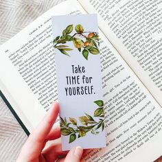 someone holding up a bookmark that says take time for yourself