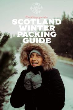 a woman in winter clothing standing next to a tree with the text scotland winter packing guide