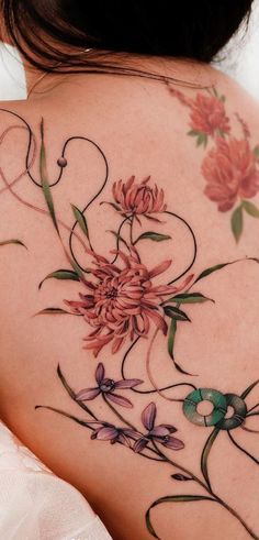 the back of a woman's shoulder with flowers on it