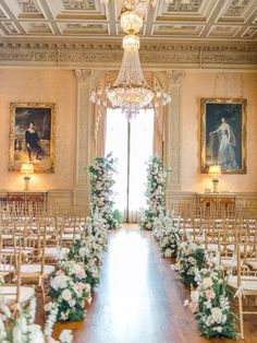 the ceremony room is decorated with white flowers and greenery