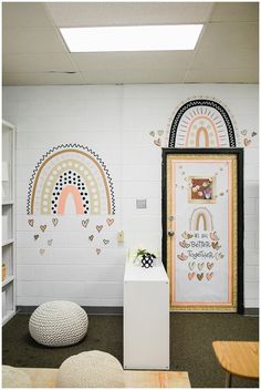 an office decorated with rainbows and hearts on the wall next to a white door