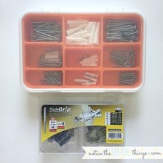 an assortment of screws and nails in a plastic container