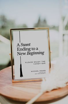 a book sitting on top of a wooden table next to a white feather and a sign