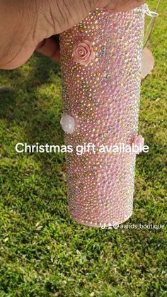 someone is holding a pink cup with glitter on it and the words christmas gift available