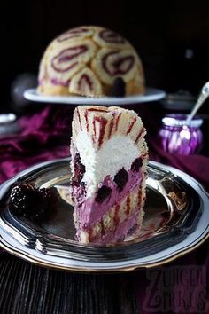 a piece of cake sitting on top of a silver plate next to another slice of cake