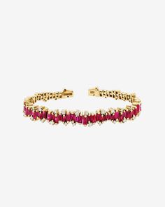 This stylish ruby bangle is handcrafted with an 18-karat spring gold wire, making it flexible and easy to slip on and off. With 4 carats of rubies, it is a beautiful statement piece that can be worn on its own or easily layered with other designs. Details 18k yellow gold or rose gold 4 carats of ruby baguettes 0.42 carats of round white diamonds 7.75mm width Ref: AKB414 Ruby Bangles, Small Rose, Refined Style, Gold Wire, White Diamonds, Eternity Bands, Yellow Color, Diamond White, Or Rose