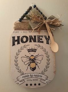 a honey sign hanging from the side of a wall