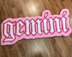 a pink and white rug with the word grandma written on it