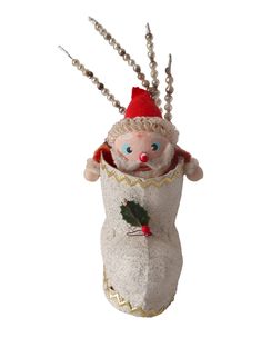 an ornament that has been made to look like a snowman holding a holly berry