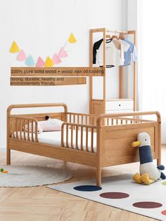 a child's bed with a wooden frame and mattress