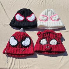 three knitted beanies with eyes on them