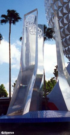 the entrance to spaceship land at disney's hollywood studios is shown in front of palm trees