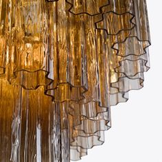 a chandelier hanging from the ceiling made out of blown glass tubes and rods