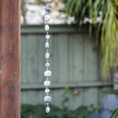 a wind chime hanging from a wooden pole