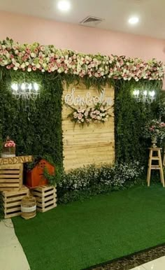 an artificial flower wall is decorated with flowers and greenery for a wedding ceremony or reception