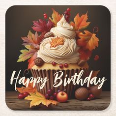 a cupcake with frosting and fall leaves on it is happy birthday beverage coaster