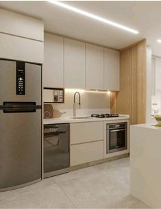 a modern kitchen with stainless steel appliances and white counter tops, along with beige cabinets