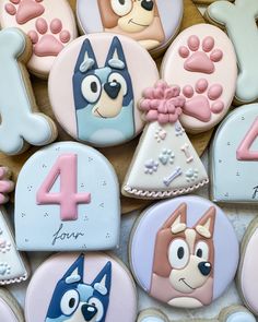 decorated cookies are arranged in the shape of dogs and numbers for children's birthdays