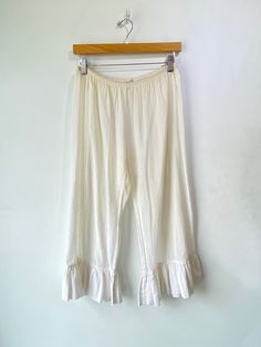 Dosa White Bloomers! These are meant to be pranced in. 100% cotton with ruffles along the hem and an elastic waistband. Hand spun in India. Marked a size 1, would best fit a medium. Signs of wear throughout, priced as is. The bum has been patched and there is some color fading. Honestly adds to the allure though. Approx. Measurements: Waist: 30-36" Rise: 10" Inseam: 21.5" Electric Feathers, Ryan Roche, Ace And Jig, Christian Wijnants, Raquel Allegra, Black Crane, Magnolia Pearl, Issey Miyake, Ulla Johnson