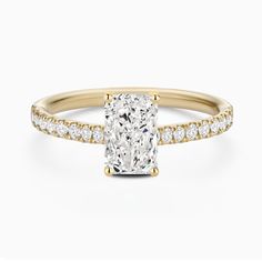 a cushion cut diamond ring with pave set shoulders