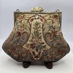 Stunning antique micro petit point purse. French??  Measuring 6" x 5" including the metal opener.  The purse features a stitched background that is shaded from tan to a blue grey. The overall floral stitching is beautiful, tiny, with pink, green, & brown florals.  The interior has tan satin interior.  Condition, interior fabric has come  loose on one side, metal frame & chain handle have not been cleaned, chain has old repair. Please check out the pictures. Please e-mail questions All Sales are final Floral Stitching, Ethiopian Opal Ring, Interior Fabric, Green Brown, Opal Rings, Clutch Handbag, Evening Bags, Purses And Handbags, Halloween Shopping