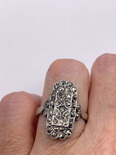 Vintage ring surrounded by Swiss cut fine Marcasite  Sterling silver  Size 7 can be sized by my jeweler. His service charge is $20  All rings are shipped in a nice gift box.   Check out our over a THOUSAND great reviews Engraving is $4 per letter and is not always perfect depending on the piece. It can take a few days if the jeweler is busy. This is payable to Paypal Judithsltd@gmail.com Vintage Silver Rectangular Diamond Ring, Collectible Silver Diamond Cut Ring, Classic Silver Rectangular Crystal Ring, Silver Rectangular Vintage Diamond Ring, Silver Rectangular Diamond Ring With Gemstone, Rectangular Silver Diamond Ring With Gemstone, Silver Diamond Ring With Rectangular Gemstone, Rectangular Silver Sterling Diamond Ring, Rectangular Silver Hallmarked Ring