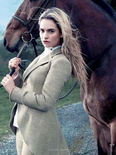 a woman standing next to a brown horse