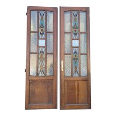 two wooden doors with stained glass panels on them