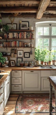 a kitchen filled with lots of counter top space next to a window and bookshelves