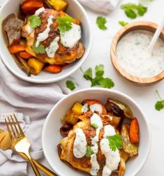 two white bowls filled with food next to silverware