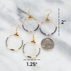 Your soon-to-be favorites, these small gold beaded hoops (available in 22 exclusive patterns) are perfect for day, night and well, everything in between. Ivory beads with rainbow colors gold-plated hoop and hooks lead-free and nickel-free glass seed beads plastic earring back 1.25" in diameter and overall length is 2" from top of hook packaged on a hand-stamped kraft earring card in a clear resealing bag Nickel-free Heishi Bead Hoop Earrings, Nickel-free Hoop Earrings With Heishi Beads, Gold Heishi Beaded Earrings With Colorful Beads, Gold Heishi Bead Earrings With Colorful Beads, Beaded 14k Gold Filled Hoop Earrings, Gold Hoop Earrings With Tiny Beads, Nickel Free Hoop Beaded Earrings For Everyday, Adjustable Hoop Earrings With Gold Beads As Gift, Adjustable Gold Beads Hoop Earrings As Gift