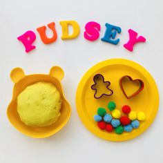 the word pudsy spelled out in plastic letters next to a plate with cookies and candies