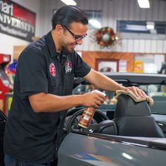 a man waxing the hood of a car