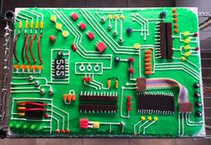 a green computer board with many electronic components on it