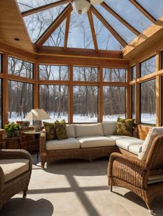 a sun room with wicker furniture and large windows