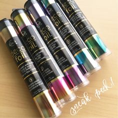 six different colors of metallic paint in plastic tubes on top of a wooden table next to the words gorili