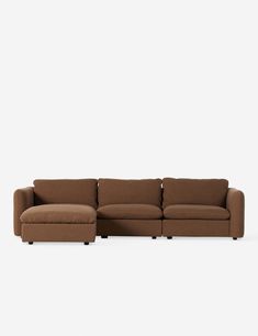 a brown sectional couch with pillows on the top and bottom, in front of a white background