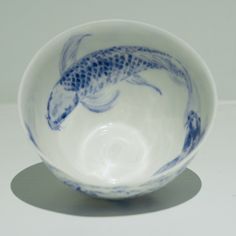 a blue and white bowl with a fish on it