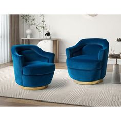 two blue chairs sitting on top of a rug