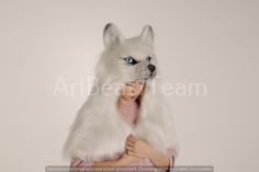 a woman wearing a white wolf costume with blue eyes and long fur on her head