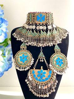 Full light blue firuza Afghan jewellery set, Afghan Jewellery Vintage Kuchi Choker Necklace, Afghan Jewellery, Afghan Fashion  Set includes:  -oversized tikka -chocker necklace  -oversized earrings  Message for any enquiries Our Aim as a business is to connect Afghan women with their roots and to make anyone that purchases our jewellery feel powerful and beautiful as each and everyone of our items is handcrafted with care and love. Blue Necklaces For Festivals Gift, Blue Necklace For Festivals And Gifts, Traditional Turquoise Jewelry Sets For Festive Occasions, Blue Bohemian Necklaces For Festive Occasions, Blue Bohemian Necklace For Festive Occasions, Festive Bohemian Blue Necklaces, Handmade Blue Jewelry For Festivals, Vintage Light Blue Handmade Jewelry, Traditional Turquoise Jewelry Sets As Gift