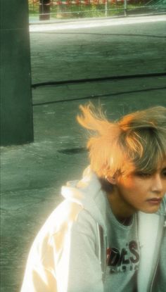 a young man sitting on top of a skateboard