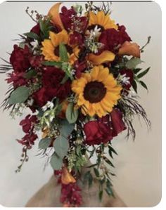 a bouquet of sunflowers and other flowers in a vase