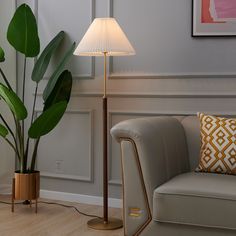 a living room scene with focus on the floor lamp and chair next to the couch