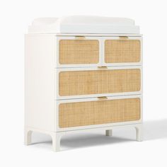 an image of a white dresser with wicker drawers on it's front and sides