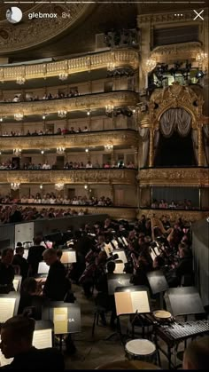 an auditorium with lots of people playing instruments