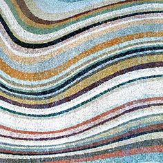 a multicolored area rug with wavy lines on the top and bottom of it