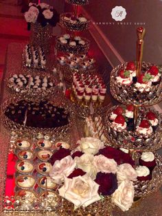 a table topped with lots of cakes and cupcakes