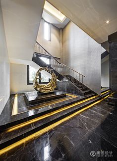 an elegant staircase with black marble and gold accents